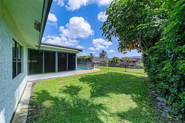 view of yard featuring a sunroom and fence