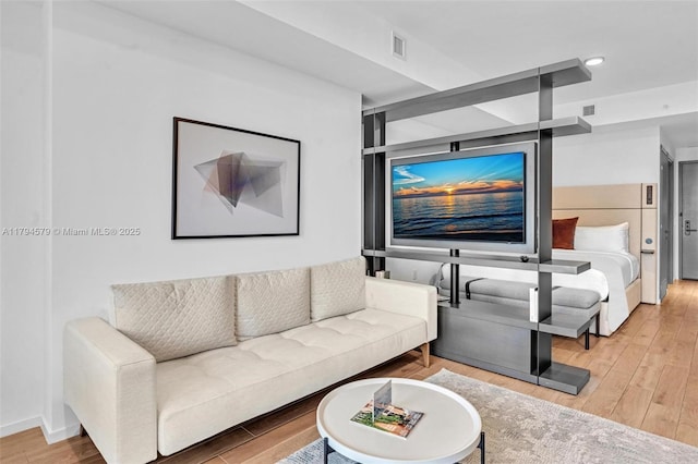 living area featuring wood finished floors and visible vents