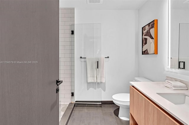 full bath featuring vanity, toilet, baseboards, tile patterned floors, and a shower stall
