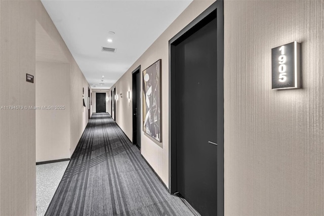 corridor with visible vents and dark colored carpet