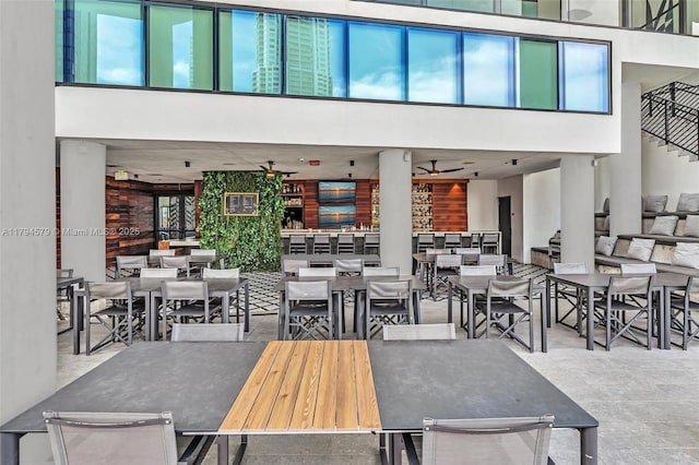view of patio / terrace with outdoor dining area, a ceiling fan, a balcony, and an outdoor living space