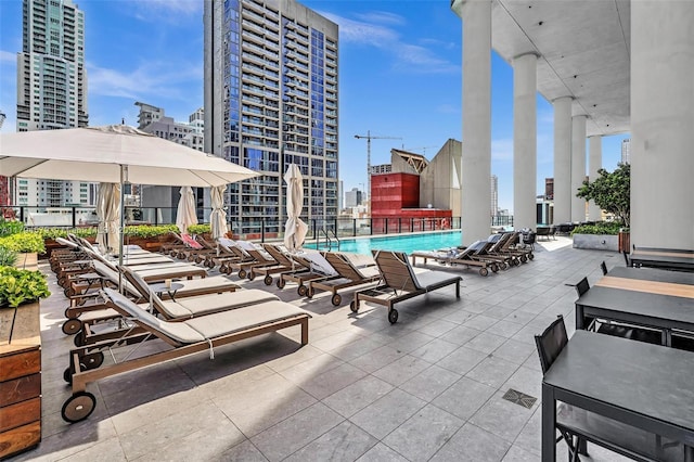 pool with a view of city and a patio area