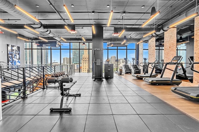 gym with a city view and floor to ceiling windows