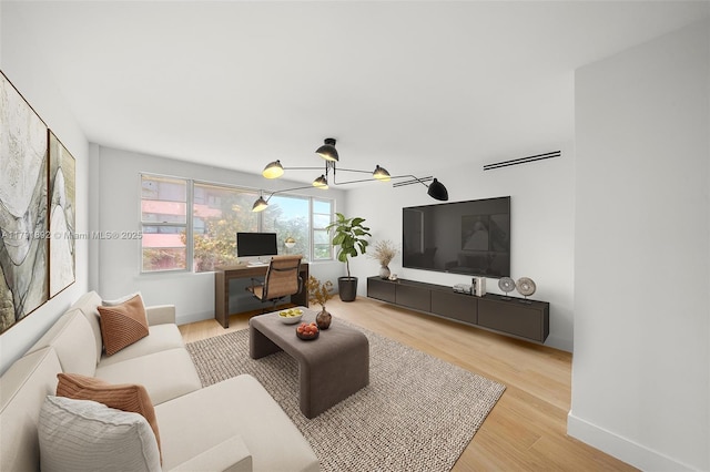 living area with baseboards and wood finished floors