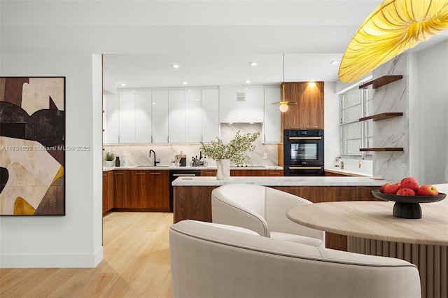 kitchen featuring white cabinets, open shelves, modern cabinets, and dobule oven black