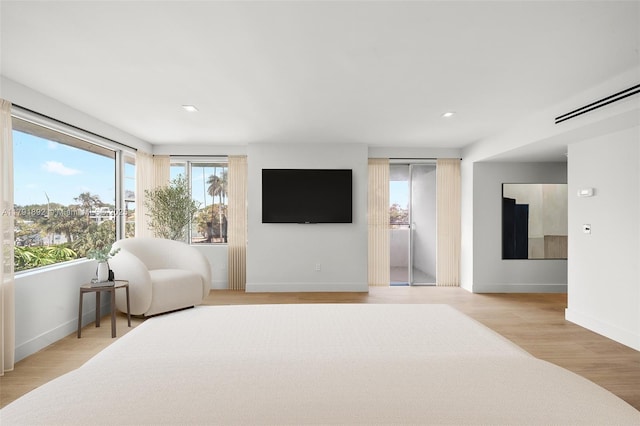 sitting room featuring recessed lighting, baseboards, visible vents, and light wood-type flooring