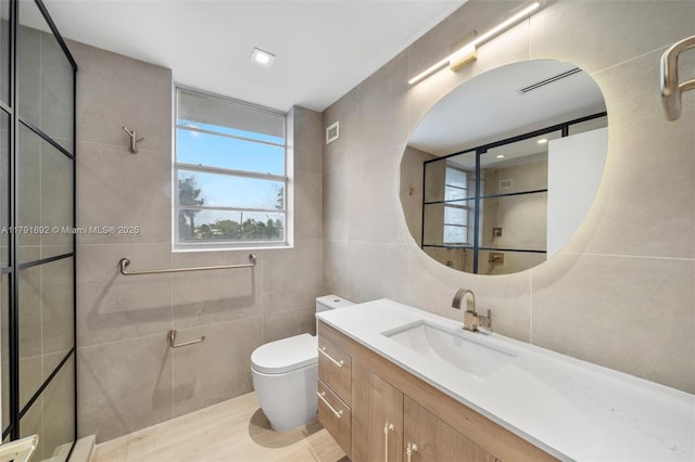 bathroom featuring vanity, visible vents, toilet, tile walls, and tiled shower