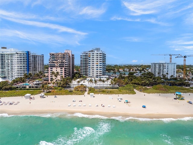 drone / aerial view with a water view and a beach view