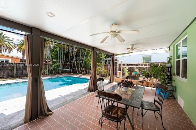 view of pool with a fenced backyard, a fenced in pool, ceiling fan, and a patio area