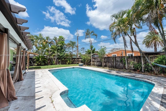 view of swimming pool with a fenced in pool, a fenced backyard, and a patio area