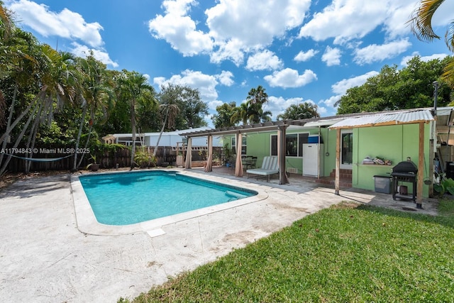 view of swimming pool with fence, a grill, a fenced in pool, a patio area, and a lawn