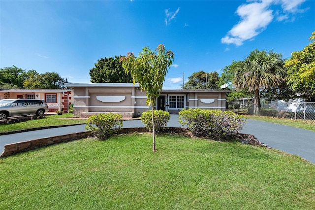 6421 NW 24th Pl, Sunrise, FL 33313 - single story home with fence, driveway, and a front lawn