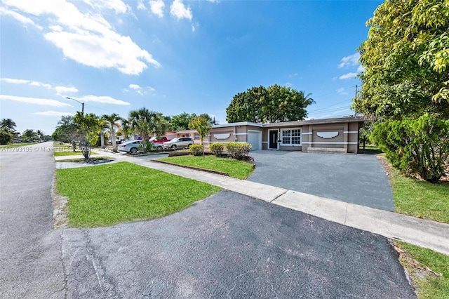6421 NW 24th Pl, Sunrise, FL 33313 - view of front of home featuring driveway and a front lawn
