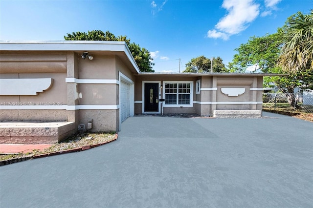 6421 NW 24th Pl, Sunrise, FL 33313 - view of front of property with a garage, fence, and stucco siding