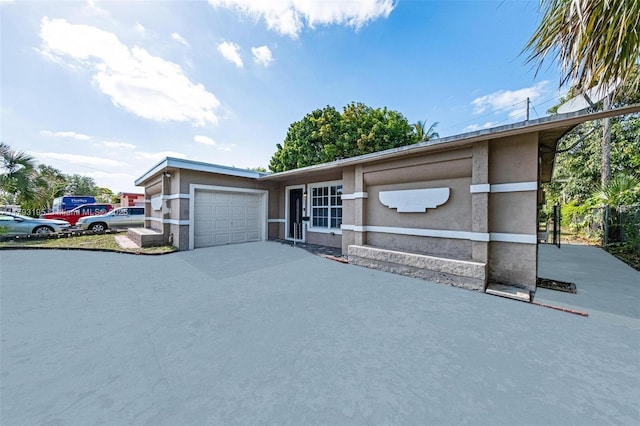 6421 NW 24th Pl, Sunrise, FL 33313 - view of front of house featuring a garage, stucco siding, and concrete driveway