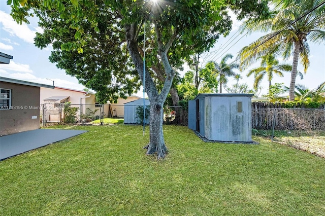 6421 NW 24th Pl, Sunrise, FL 33313 - view of yard with a fenced backyard, a storage unit, and an outdoor structure