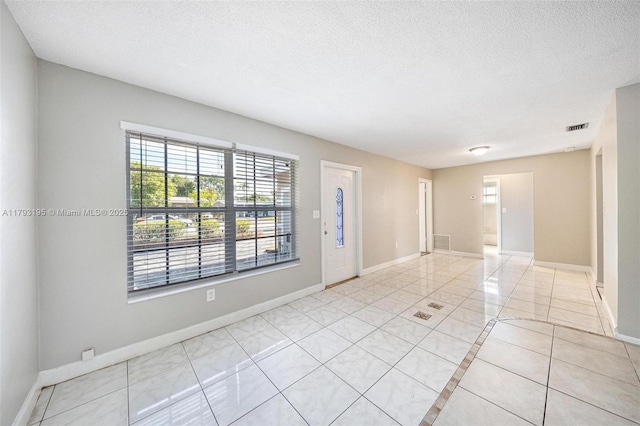 6421 NW 24th Pl, Sunrise, FL 33313 - unfurnished room with visible vents, baseboards, a textured ceiling, and light tile patterned floors