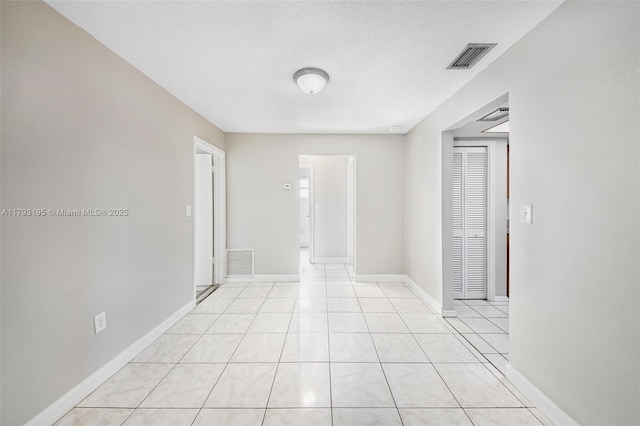 6421 NW 24th Pl, Sunrise, FL 33313 - unfurnished room with visible vents, a textured ceiling, baseboards, and light tile patterned flooring