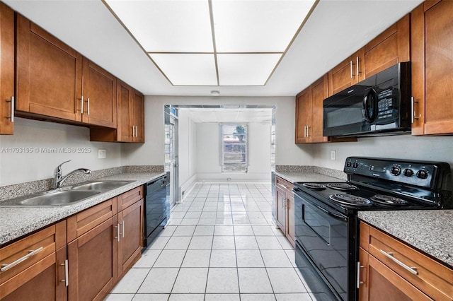 6421 NW 24th Pl, Sunrise, FL 33313 - kitchen with brown cabinets, a sink, light countertops, light tile patterned floors, and black appliances