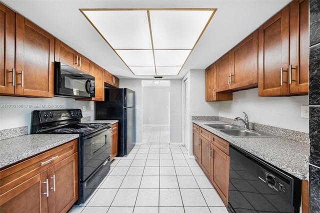 6421 NW 24th Pl, Sunrise, FL 33313 - kitchen featuring a sink, light tile patterned floors, brown cabinetry, and black appliances
