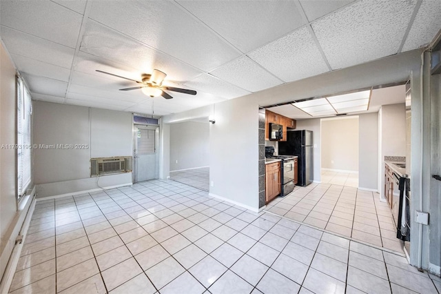 6421 NW 24th Pl, Sunrise, FL 33313 - unfurnished living room with baseboards, a paneled ceiling, ceiling fan, and light tile patterned floors