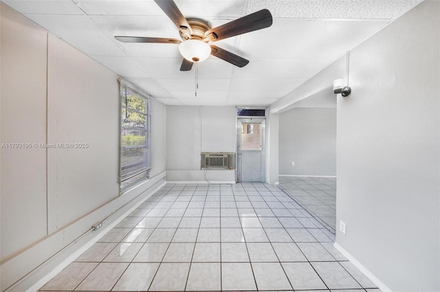 6421 NW 24th Pl, Sunrise, FL 33313 - unfurnished living room featuring light tile patterned floors, baseboards, a ceiling fan, and a wall mounted air conditioner