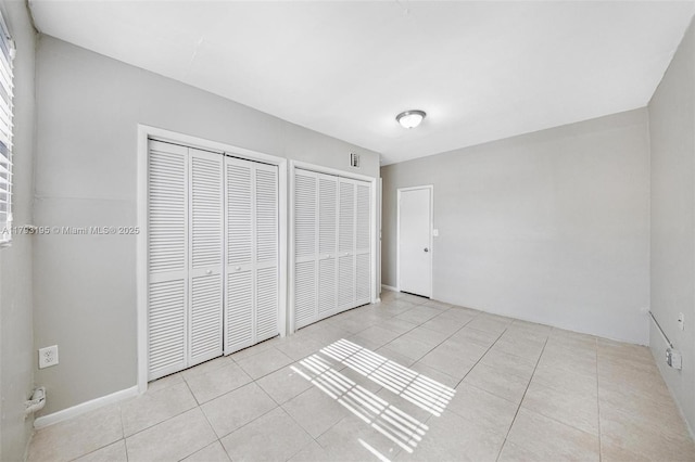 6421 NW 24th Pl, Sunrise, FL 33313 - unfurnished bedroom with light tile patterned flooring