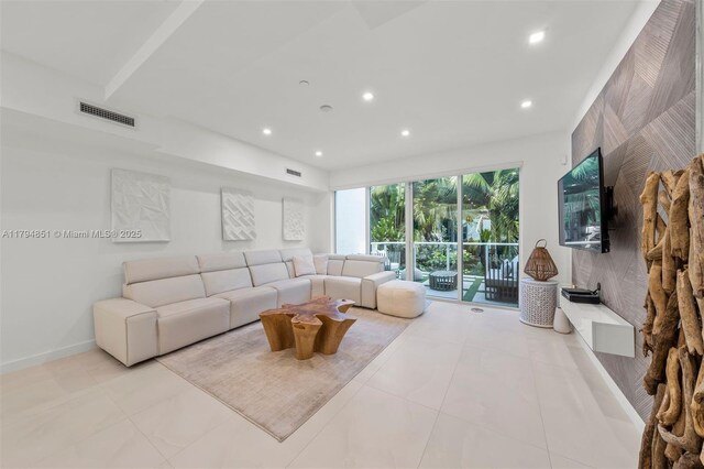 living area featuring recessed lighting, baseboards, visible vents, and light tile patterned floors