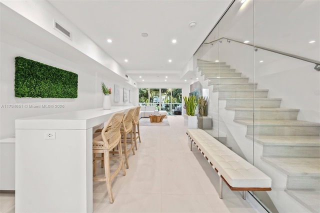 staircase with recessed lighting, tile patterned floors, and visible vents