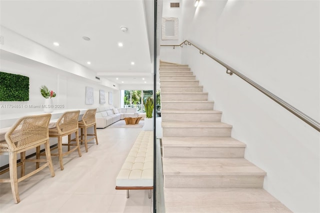 stairs with recessed lighting and tile patterned flooring