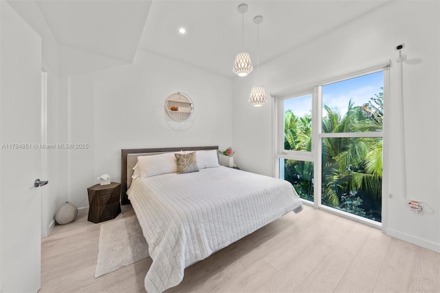 bedroom featuring recessed lighting, baseboards, a notable chandelier, and light wood finished floors