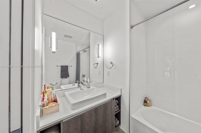 bathroom featuring vanity,  shower combination, and visible vents