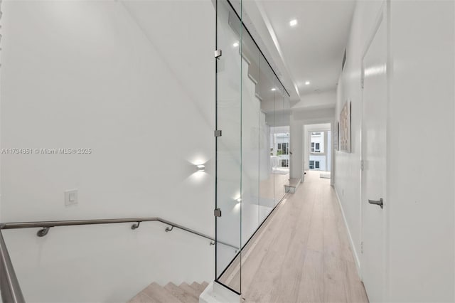 corridor featuring light wood-style floors and recessed lighting