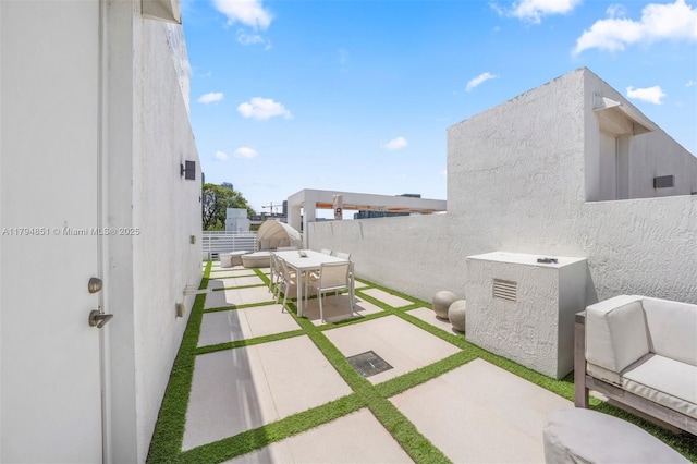 view of patio featuring fence and outdoor dining space