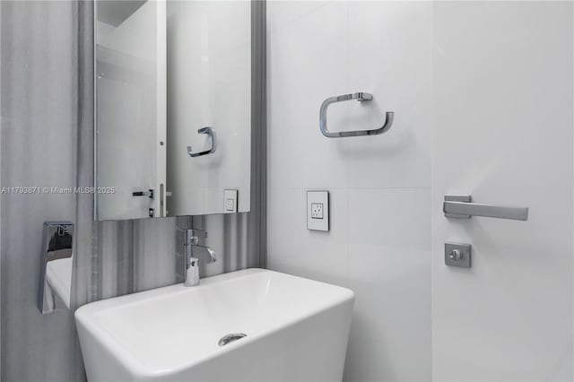 5875 Collins Ave Unit 1908, Miami Beach, FL 33140 - bathroom with tile walls and a sink