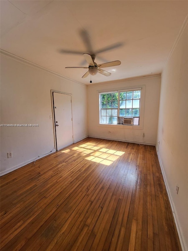 unfurnished room featuring crown molding, a ceiling fan, wood-type flooring, and baseboards