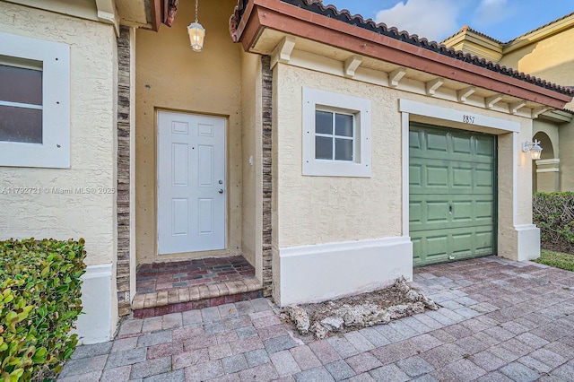8857 SW 222nd Ter, Cutler Bay, FL 33190 - doorway to property with a tile roof and stucco siding