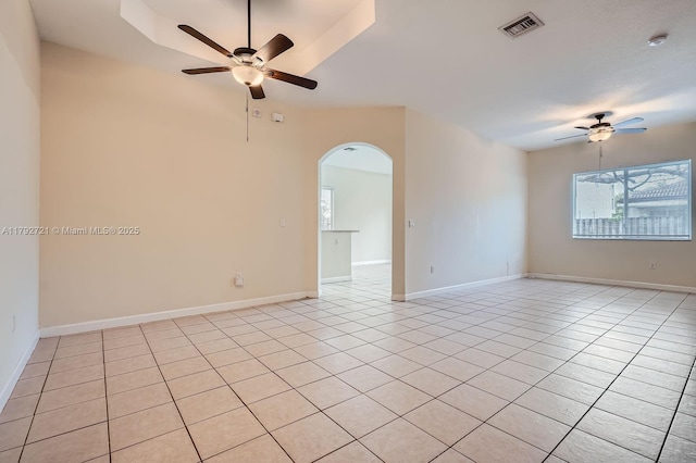 8857 SW 222nd Ter, Cutler Bay, FL 33190 - empty room featuring visible vents, baseboards, ceiling fan, arched walkways, and light tile patterned floors