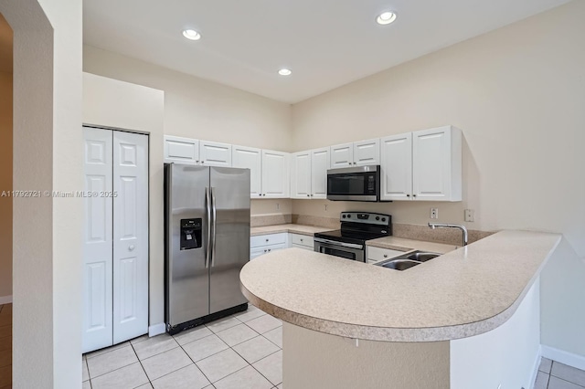 8857 SW 222nd Ter, Cutler Bay, FL 33190 - kitchen with a peninsula, light countertops, a sink, appliances with stainless steel finishes, and light tile patterned floors