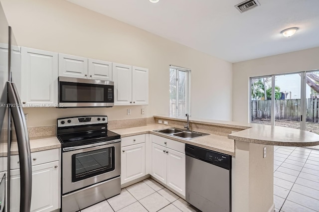 8857 SW 222nd Ter, Cutler Bay, FL 33190 - kitchen featuring visible vents, appliances with stainless steel finishes, a sink, light tile patterned floors, and a peninsula