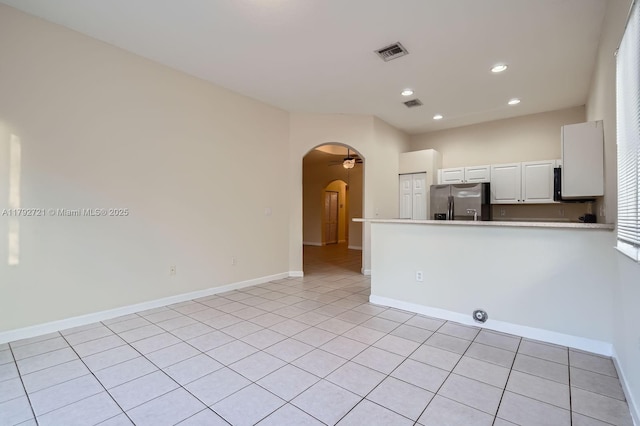 8857 SW 222nd Ter, Cutler Bay, FL 33190 - unfurnished room featuring arched walkways, baseboards, light tile patterned flooring, and visible vents