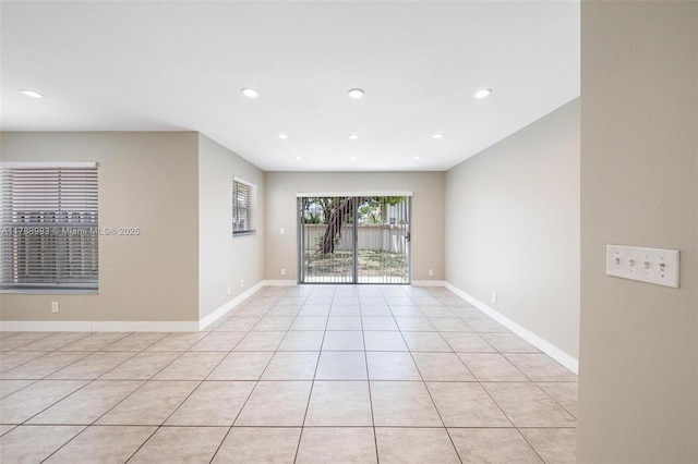 unfurnished room featuring recessed lighting, baseboards, and light tile patterned floors
