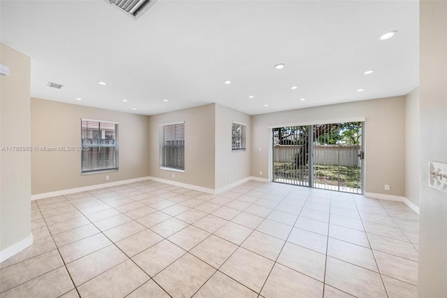 empty room with recessed lighting, baseboards, visible vents, and light tile patterned floors