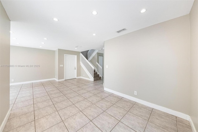 empty room featuring visible vents, recessed lighting, baseboards, and light tile patterned floors