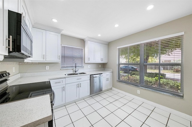 kitchen featuring light countertops, recessed lighting, appliances with stainless steel finishes, and a sink