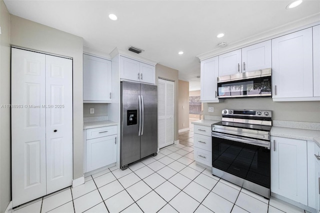 kitchen with visible vents, appliances with stainless steel finishes, light countertops, recessed lighting, and white cabinetry