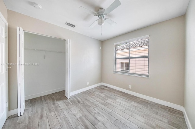 unfurnished bedroom featuring visible vents, baseboards, and light wood-type flooring