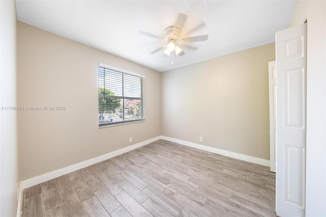 empty room with ceiling fan, baseboards, and light wood finished floors