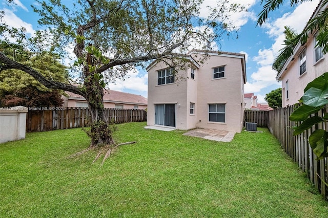 back of house featuring a patio, a fenced backyard, stucco siding, central AC unit, and a yard