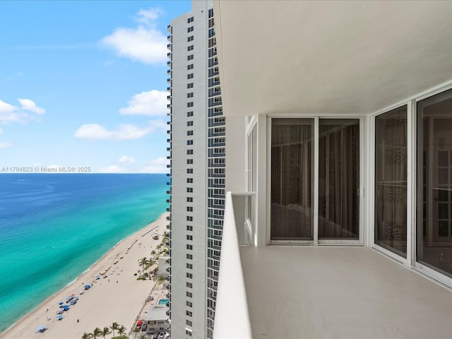 balcony with a view of the beach and a water view